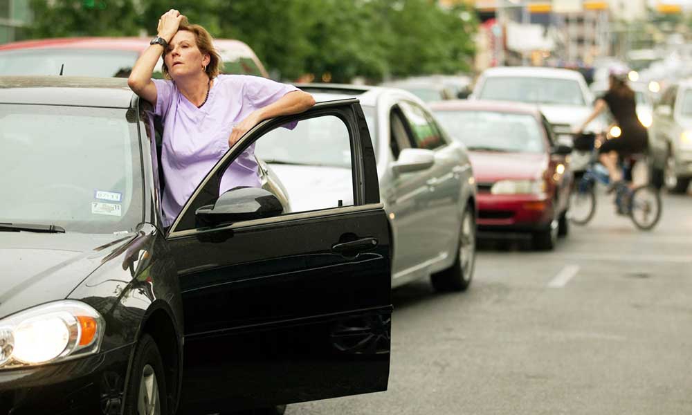 be stuck in traffic